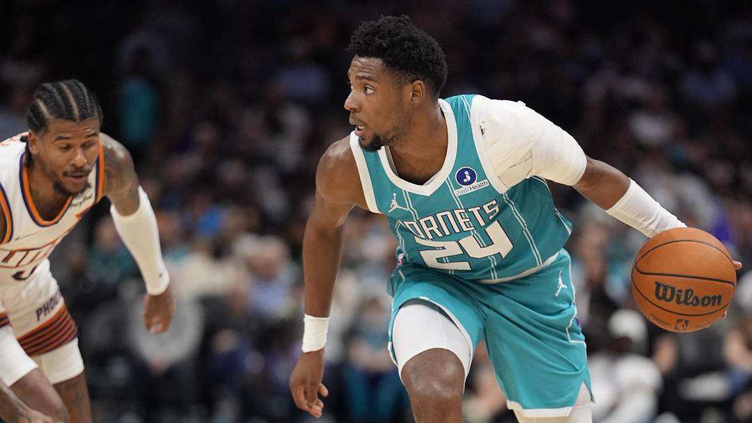 Charlotte Hornets forward Brandon Miller (24) moves the ball against Phoenix Suns guard Jalen Green 