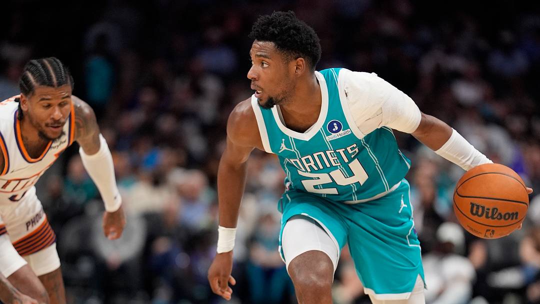 Charlotte Hornets forward Brandon Miller (24) moves the ball against Phoenix Suns guard Jalen Green 