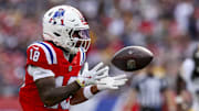 Sep 21, 2025; Foxborough, Massachusetts, USA; New England Patriots wide receiver Kyle Williams (18) completes a pass during the third quarter at Gillette Stadium. Mandatory Credit: Paul Rutherford-Imagn Images