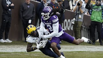 Nov 15, 2025; Chicago, Illinois, USA; Michigan Wolverines wide receiver Andrew Marsh (4) makes a catch as Northwestern Wildcats cornerback Fred Davis II (2) defends him during the first half at Wrigley Field. Mandatory Credit: David Banks-Imagn Images