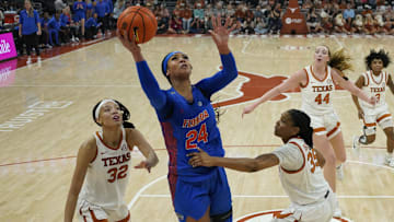 Mar 2, 2025; Austin, Texas, USA; Florida Gators center Ra Shaya Kyle (24) shoots over Texas Longhorns guard Ndjakalenga Mwenentanda (32) and forward Madison Booker (35) during the first half at Moody Center. Mandatory Credit: Scott Wachter-Imagn Images
