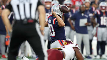Aug 8, 2025; Foxborough, Massachusetts, USA; Washington Commanders defensive tackle Johnny Newton (95) tackles New England Patriots quarterback Drake Maye (10) during the first half at Gillette Stadium. Mandatory Credit: Paul Rutherford-Imagn Images