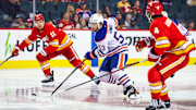 Sep 21, 2025; Calgary, Alberta, CAN; Edmonton Oilers left wing Isaac Howard (53) controls the puck against the Calgary Flames during the first period at Scotiabank Saddledome. Mandatory Credit: Sergei Belski-Imagn Images