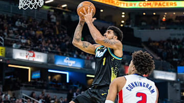 Nov 24, 2023; Indianapolis, Indiana, USA; Indiana Pacers forward Obi Toppin (1) shoots the ball while Cade Cunningham of the Detroit Pistons watches.