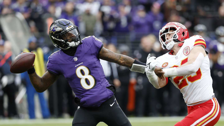 Jan 28, 2024; Baltimore, Maryland, USA; Baltimore Ravens quarterback Lamar Jackson (8) prepares to throw the ball as Kansas City Chiefs linebacker Drue Tranquill (23) defends during the first half in the AFC Championship football game at M&T Bank Stadium. Mandatory Credit: Geoff Burke-USA TODAY Sports