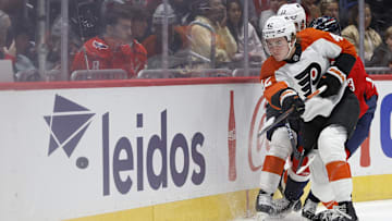Sep 22, 2024; Washington, District of Columbia, USA; Philadelphia Flyers defenseman Spencer Gill (42) clears the puck from Washington Capitals forward Jakub Vrana (13) in the third period at Capital One Arena. 