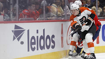 Sep 22, 2024; Washington, District of Columbia, USA; Philadelphia Flyers defenseman Spencer Gill (42) clears the puck from Washington Capitals forward Jakub Vrana (13) in the third period at Capital One Arena.