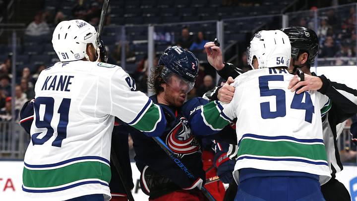 Jan 15, 2026; Columbus, Ohio, USA; Columbus Blue Jackets defenseman Jake Christiansen (2) scrums with Vancouver center Aatu Raty (54) and left wing Evander Kane (91) during the first period at Nationwide Arena. Mandatory Credit: Russell LaBounty-Imagn Images