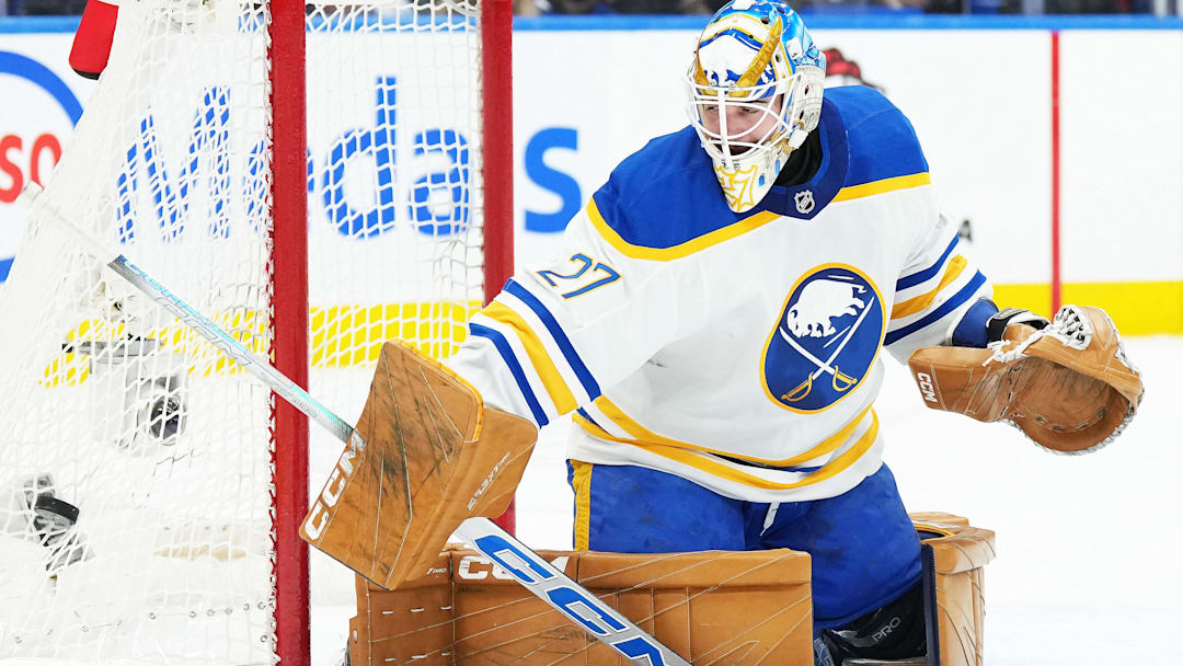 Dec 15, 2024; Toronto, Ontario, CAN; Buffalo Sabres goaltender Devon Levi (27) steers the puck to the side of the net against the Toronto Maple Leafs during the first period at Scotiabank Arena. Mandatory Credit: Nick Turchiaro-Imagn Images