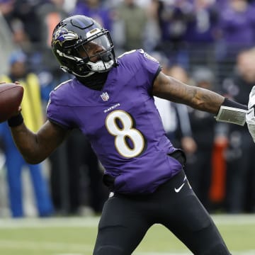 Jan 28, 2024; Baltimore, Maryland, USA; Baltimore Ravens quarterback Lamar Jackson (8) prepares to throw the ball as Kansas City Chiefs linebacker Drue Tranquill (23) defends during the first half in the AFC Championship football game at M&T Bank Stadium. Mandatory Credit: Geoff Burke-USA TODAY Sports