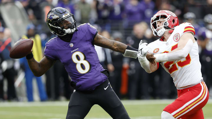 Jan 28, 2024; Baltimore, Maryland, USA; Baltimore Ravens quarterback Lamar Jackson (8) prepares to throw the ball as Kansas City Chiefs linebacker Drue Tranquill (23) defends during the first half in the AFC Championship football game at M&T Bank Stadium. Mandatory Credit: Geoff Burke-USA TODAY Sports