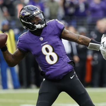 Jan 28, 2024; Baltimore, Maryland, USA; Baltimore Ravens quarterback Lamar Jackson (8) prepares to throw the ball as Kansas City Chiefs linebacker Drue Tranquill (23) defends during the first half in the AFC Championship football game at M&T Bank Stadium. Mandatory Credit: Geoff Burke-USA TODAY Sports