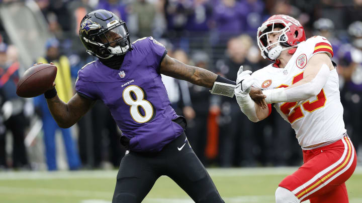 Jan 28, 2024; Baltimore, Maryland, USA; Baltimore Ravens quarterback Lamar Jackson (8) prepares to throw the ball as Kansas City Chiefs linebacker Drue Tranquill (23) defends during the first half in the AFC Championship football game at M&T Bank Stadium. Mandatory Credit: Geoff Burke-USA TODAY Sports