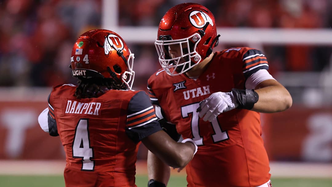 Oct 11, 2025; Salt Lake City, Utah, USA; Utah Utes quarterback Devon Dampier (4) celebrates scoring a touchdown against the Arizona State Sun Devils with Utah Utes offensive lineman Caleb Lomu (71) during the second quarter at Rice-Eccles Stadium. Mandatory Credit: Rob Gray-Imagn Images Oct 11, 2025; Salt Lake City, Utah, USA; Utah Utes quarterback Devon Dampier (4) celebrates scoring a touchdown against the Arizona State Sun Devils with Utah Utes offensive lineman Caleb Lomu (71) during the second quarter at Rice-Eccles Stadium. Mandatory Credit: Rob Gray-Imagn Images