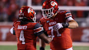 Utah Utes QB Devon Dampier celebrates scoring a touchdown against the Arizona State Sun Devils with OT Caleb Lomu.