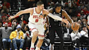 Dec 2, 2024; Chicago, Illinois, USA; Chicago Bulls center Nikola Vucevic (9) and Brooklyn Nets center Nic Claxton (33) chase the ball during the second half at the United Center. Mandatory Credit: Matt Marton-Imagn Images