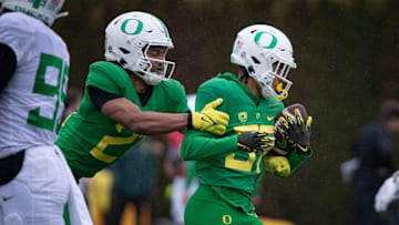 Oregon defensive back Aaron Flowers tackles defensive back Hunter Roberts during practice with the Oregon Ducks Thursday, April 4, 2024, at the Hatfield-Dowlin Complex in Eugene, Ore.