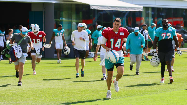 Miami Dolphins quarterback Mike White (14) runs on the field during joint practice with the Washington Commanders at Baptist Health Training Complex on Thursday.