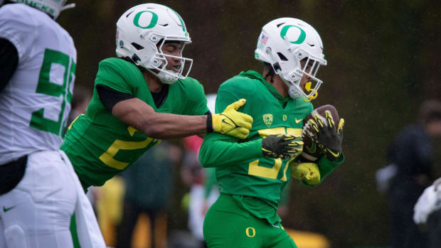 regon defensive back Aaron Flowers tackles defensive back Hunter Roberts during practice with the Oregon Ducks