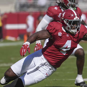 Oct 12, 2024; Tuscaloosa, Alabama, USA;  Alabama Crimson Tide linebacker Qua Russaw (4) tries to bring down South Carolina Gamecocks quarterback Robby Ashford (1) at Bryant-Denny Stadium. Mandatory Credit: Gary Cosby Jr.-Imagn Images