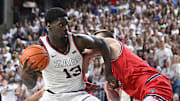 Feb 22, 2025; Spokane, Washington, USA; Gonzaga Bulldogs forward Graham Ike (13) is fouled on the shot by St. Mary's Gaels center Mitchell Saxen (11) in the second half at McCarthey Athletic Center. Mandatory Credit: James Snook-Imagn Images