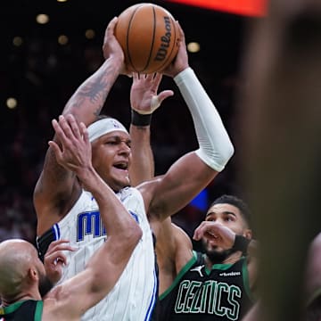 Apr 29, 2025; Boston, Massachusetts, USA; Boston Celtics guard Derrick White (9) and forward Jayson Tatum (0) defend against Orlando Magic forward Paolo Banchero (5) in the second quarter during game five of first round for the 2025 NBA Playoffs at TD Garden. Mandatory Credit: David Butler II-Imagn Images