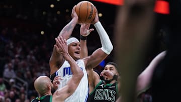 Boston Celtics guard Derrick White (9) and forward Jayson Tatum (0) defend against Orlando Magic forward Paolo Banchero (5) in the second quarter during game five of first round for the 2025 NBA Playoffs at TD Garden.