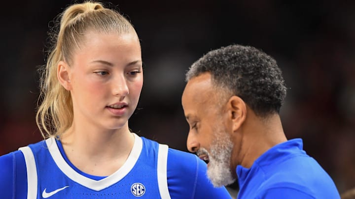 Kentucky Wildcats center Clara Strack (13) talks to Kentucky Wildcats head coach Kenny Brooks Friday, March 6, 2026, during the SEC Women's Basketball Tournament quarterfinals game against the South Carolina Gamecocks at Bon Secours Wellness Arena in Greenville, South Carolina.