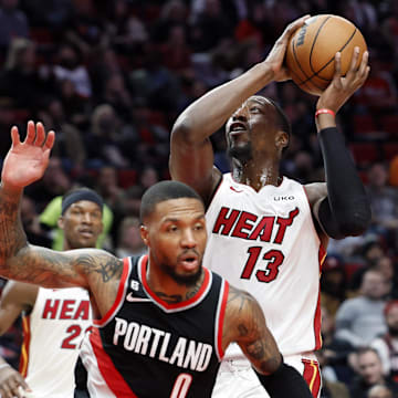 Oct 26, 2022; Portland, Oregon, USA;  Miami Heat center Bam Adebayo (13) drives to the basket past Portland Trail Blazers point guard Damian Lillard (0) during the second half at Moda Center. Mandatory Credit: Soobum Im-Imagn Images