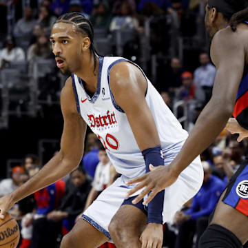 Mar 13, 2025; Detroit, Michigan, USA;  Washington Wizards forward Alex Sarr (20) dribbles defended by Detroit Pistons center Isaiah Stewart (28) in the first half at Little Caesars Arena. Mandatory Credit: Rick Osentoski-Imagn Images