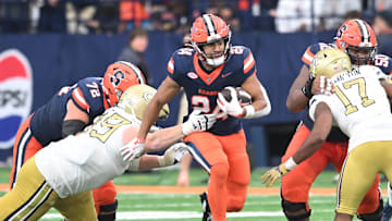 Sep 7, 2024; Syracuse, New York, USA; Syracuse Orange running back Will Nixon (24) runs through a gap in the Georgia Tech Yellow Jackets defense in the third quarter at the JMA Wireless Dome. Mandatory Credit: Mark Konezny-Imagn Images