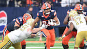 Sep 7, 2024; Syracuse, New York, USA; Syracuse Orange running back Will Nixon (24) runs through a gap in the Georgia Tech Yellow Jackets defense in the third quarter at the JMA Wireless Dome. Mandatory Credit: Mark Konezny-Imagn Images