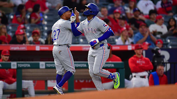 Texas Rangers outfielder Adolis Garcia celebrates his 25th home run with third base coach Tony Beasley on Friday in Anaheim. Texas Rangers outfielder Adolis Garcia celebrates his 25th home run with third base coach Tony Beasley on Friday in Anaheim.
