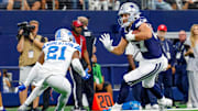 Dallas Cowboys TE Jake Ferguson catches a pass with Detroit Lions CB Amik Robertson defending.