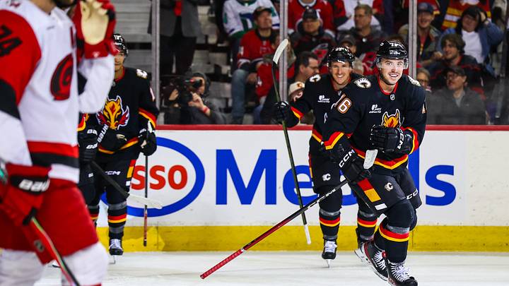 Mar 7, 2026; Calgary, Alberta, CAN; Calgary Flames center Morgan Frost (16) celebrates his goal with teammates against the Carolina Hurricanes during the second period at Scotiabank Saddledome. Mandatory Credit: Sergei Belski-Imagn Images