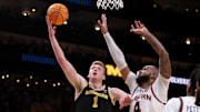 Mar 28, 2025; Atlanta, GA, USA; Michigan Wolverines center Danny Wolf (1) shoots against Auburn Tigers forward Johni Broome (4) in the second half of a South Regional semifinal of the 2025 NCAA tournament at State Farm Arena.