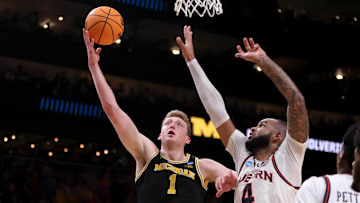 Mar 28, 2025; Atlanta, GA, USA; Michigan Wolverines center Danny Wolf (1) shoots against Auburn Tigers forward Johni Broome (4) in the second half of a South Regional semifinal of the 2025 NCAA tournament at State Farm Arena.