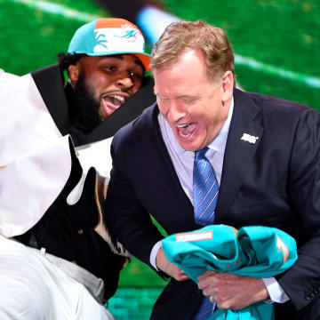 Christian Wilkins celebrates his pick by the Miami Dolphins with NFL Commissioner Roger Goodell during the first round of the 2019 NFL Draft.