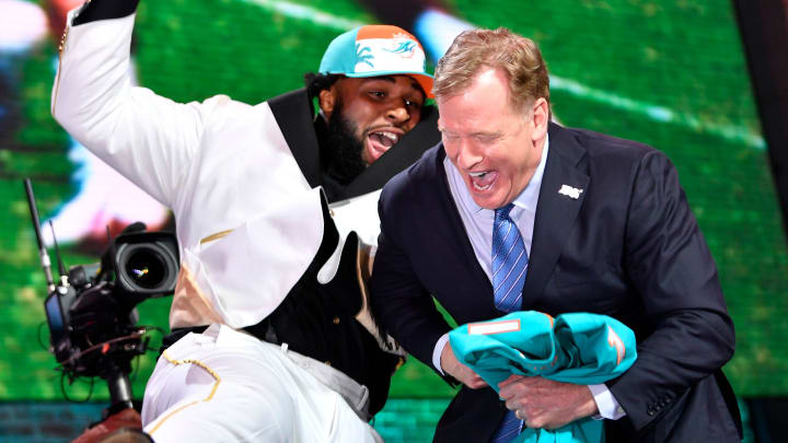 Christian Wilkins celebrates his pick by the Miami Dolphins with NFL Commissioner Roger Goodell during the first round of the 2019 NFL Draft.