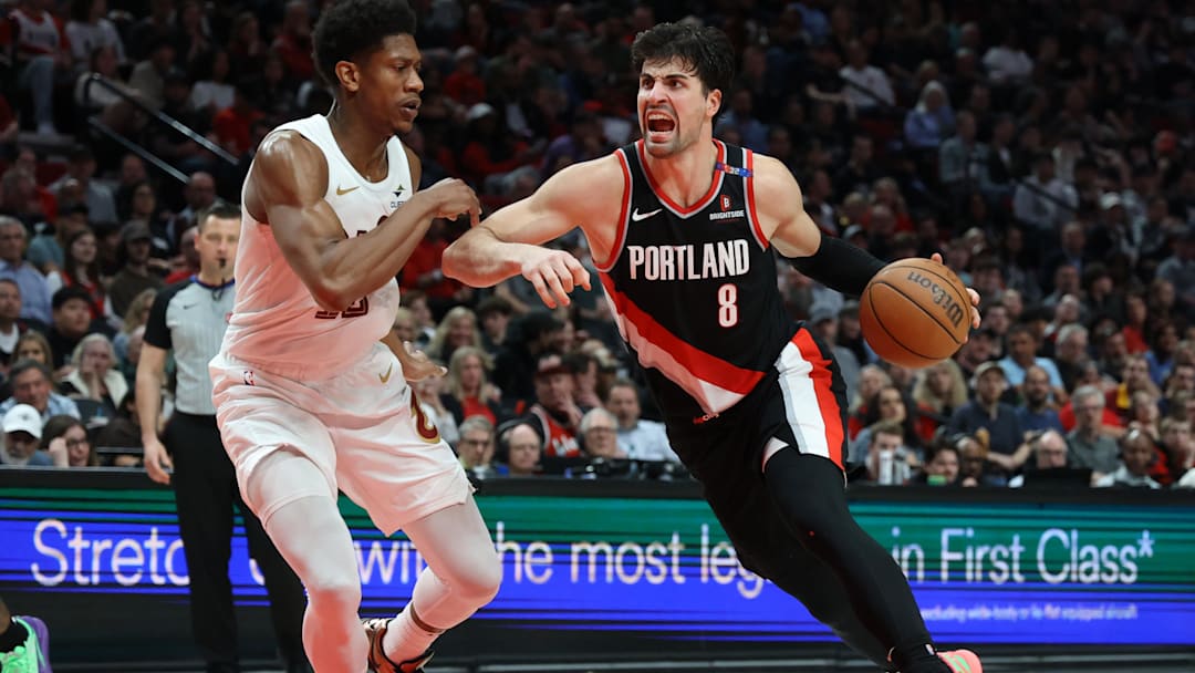 Mar 25, 2025; Portland, Oregon, USA; Portland Trail Blazers forward Deni Avdija (8) drives to the basket against Cleveland Cavaliers forward De'Andre Hunter (12) in the second half at Moda Center. Mandatory Credit: Jaime Valdez-Imagn Images
