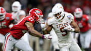Jan 1, 2019; New Orleans, LA, USA; Texas Longhorns wide receiver Collin Johnson (9) runs against Georgia Bulldogs defensive back Eric Stokes (27) after a catch in the second half of the 2019 Sugar Bowl at the Mercedes-Benz Superdome. The Texas Longhorns won 28-21. Mandatory Credit: Chuck Cook-Imagn Images