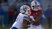 Kansas redshirt junior quarterback Jalon Daniels (6) hands off to senior running back Devin Neal (4) during Friday's Spring Preview at Rock Chalk Park.