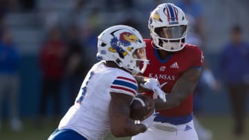 Kansas redshirt junior quarterback Jalon Daniels (6) hands off to senior running back Devin Neal (4) during Friday's Spring Preview at Rock Chalk Park.