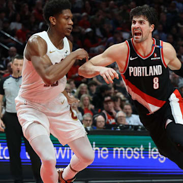 Mar 25, 2025; Portland, Oregon, USA; Portland Trail Blazers forward Deni Avdija (8) drives to the basket against Cleveland Cavaliers forward De'Andre Hunter (12) in the second half at Moda Center. Mandatory Credit: Jaime Valdez-Imagn Images