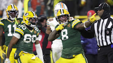 Nov 28, 2024; Green Bay, Wisconsin, USA; Green Bay Packers running back Josh Jacobs (8) celebrates after a long reception and run in the fourth quarter against the Miami Dolphins at Lambeau Field. Mandatory Credit: Dan Powers-Imagn Images