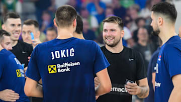 Nikola Jokic of Serbia and Luka Doncic of Slovenia shake...