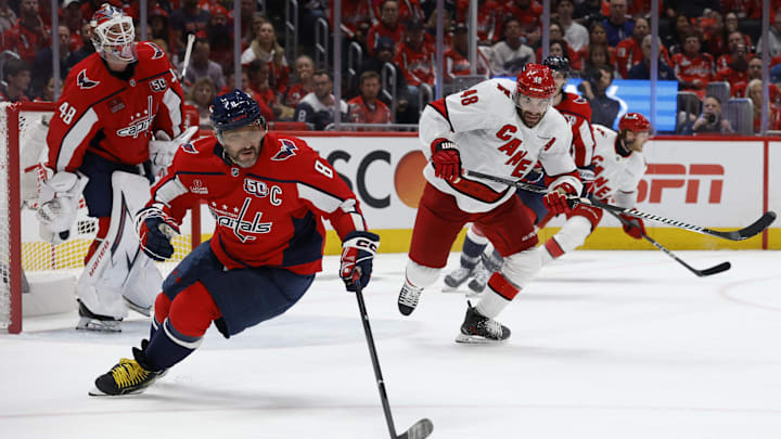 May 6, 2025; Washington, District of Columbia, USA; Washington Capitals left wing Alex Ovechkin (8) controls the puck in front of Capitals goaltender Logan Thompson (48) as Carolina Hurricanes left wing Jordan Martinook (48) chases in the second period in game one of the second round of the 2025 Stanley Cup Playoffs at Capital One Arena. Mandatory Credit: Geoff Burke-Imagn Images