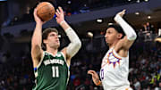 Apr 1, 2025; Milwaukee, Wisconsin, USA;  Milwaukee Bucks center Brook Lopez (11) takes a shot against Phoenix Suns guard Ryan Dunn (0) in the third quarter at Fiserv Forum. Mandatory Credit: Benny Sieu-Imagn Images