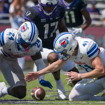 SMU Mustangs running back Velton Gardner (24) and place kicker Collin Rogers (41) and TCU Horned Frogs running back Trent Battle (17) and running back Trey Sanders (2) battle for the onside kick during the second half at Amon G. Carter Stadium. 