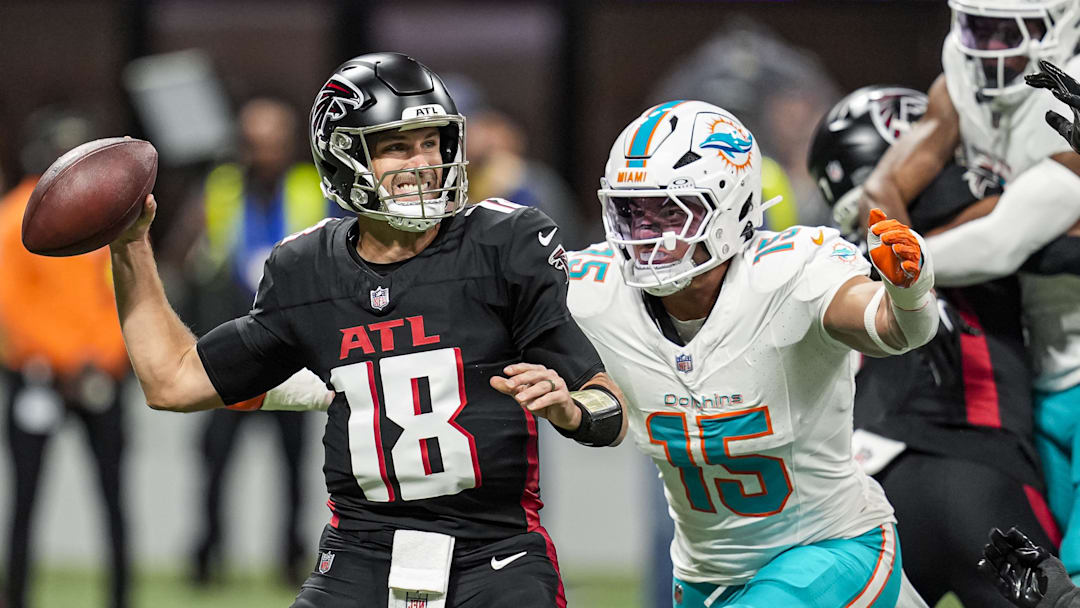 Oct 26, 2025; Atlanta, Georgia, USA; Atlanta Falcons quarterback Kirk Cousins (18) passes under pressure from Miami Dolphins linebacker Jaelan Phillips (15) during the first quarter at Mercedes-Benz Stadium. Mandatory Credit: Dale Zanine-Imagn Images